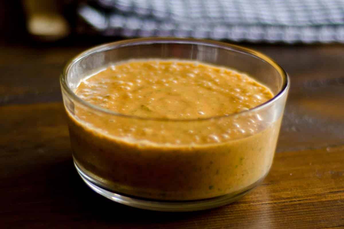 Raw Tomato Sauce in a glass bowl on a wood table