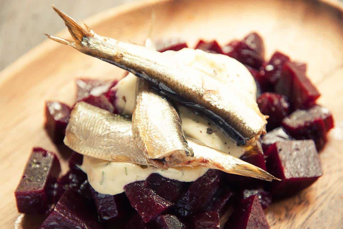white plate filled with Roasted beet and canned sardine salad