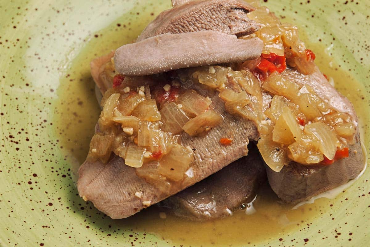 closeup of Slow Cooked Beef Tongue in a green bowl