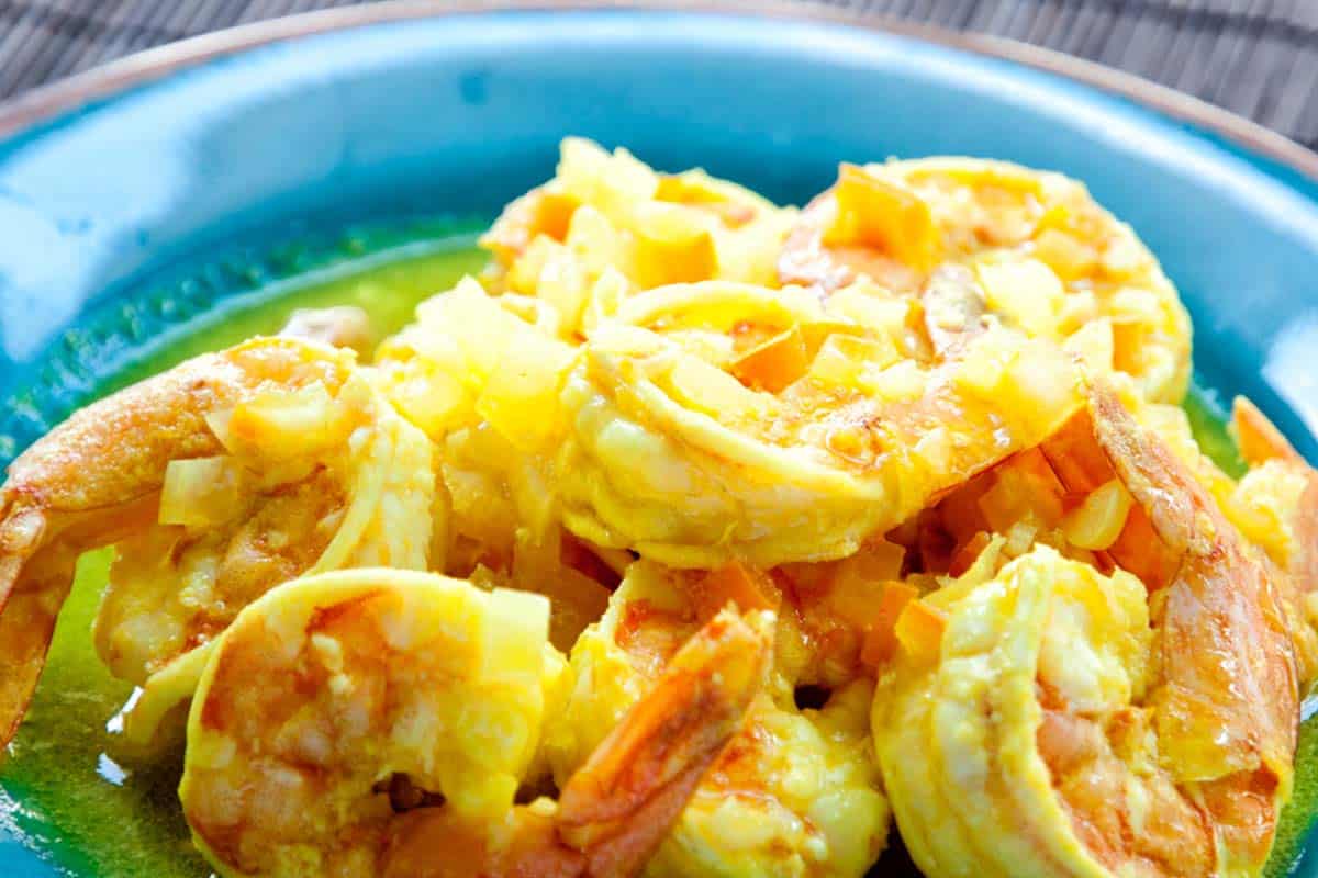 blue bowl filled with a serving of Spicy Shrimp Stir-Fry