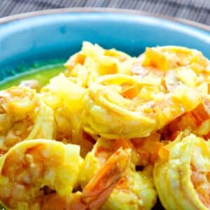 closeup of spicy shrimp stir-fry in a blue bowl