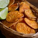 Sweet potato chips and sliced lime in a basket