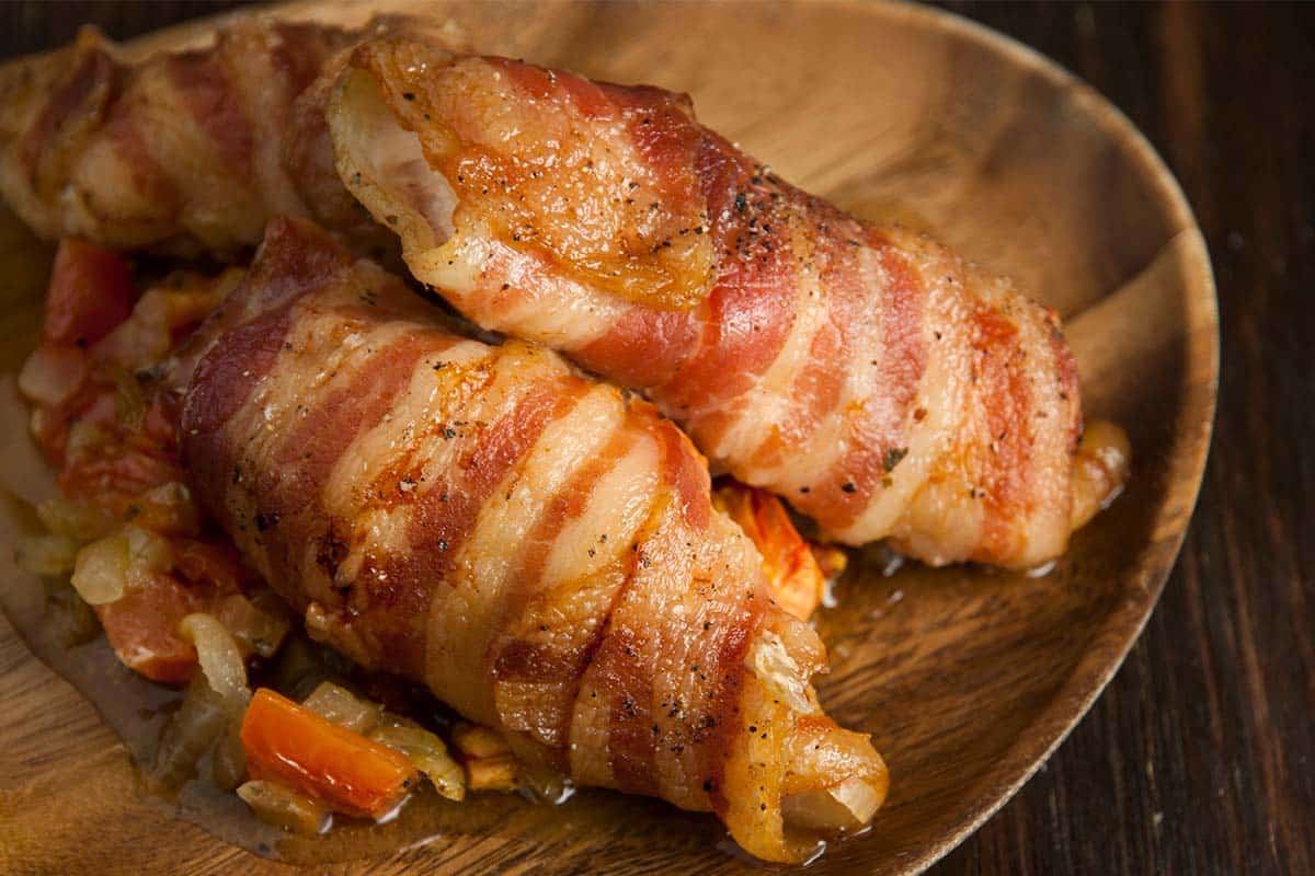 Sweetbreads with bacon on a wood serving tray