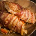 closeup of Sweetbreads with bacon on a wood serving tray