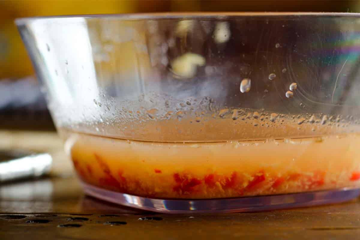 side view of a glass bowl of Thai honey marinade