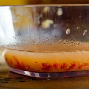 closeup of the side of a glass bowl of Thai honey marinade