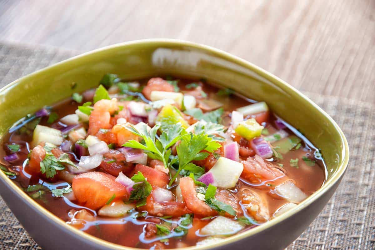 closeup of Vegetable gazpacho in a square bowl