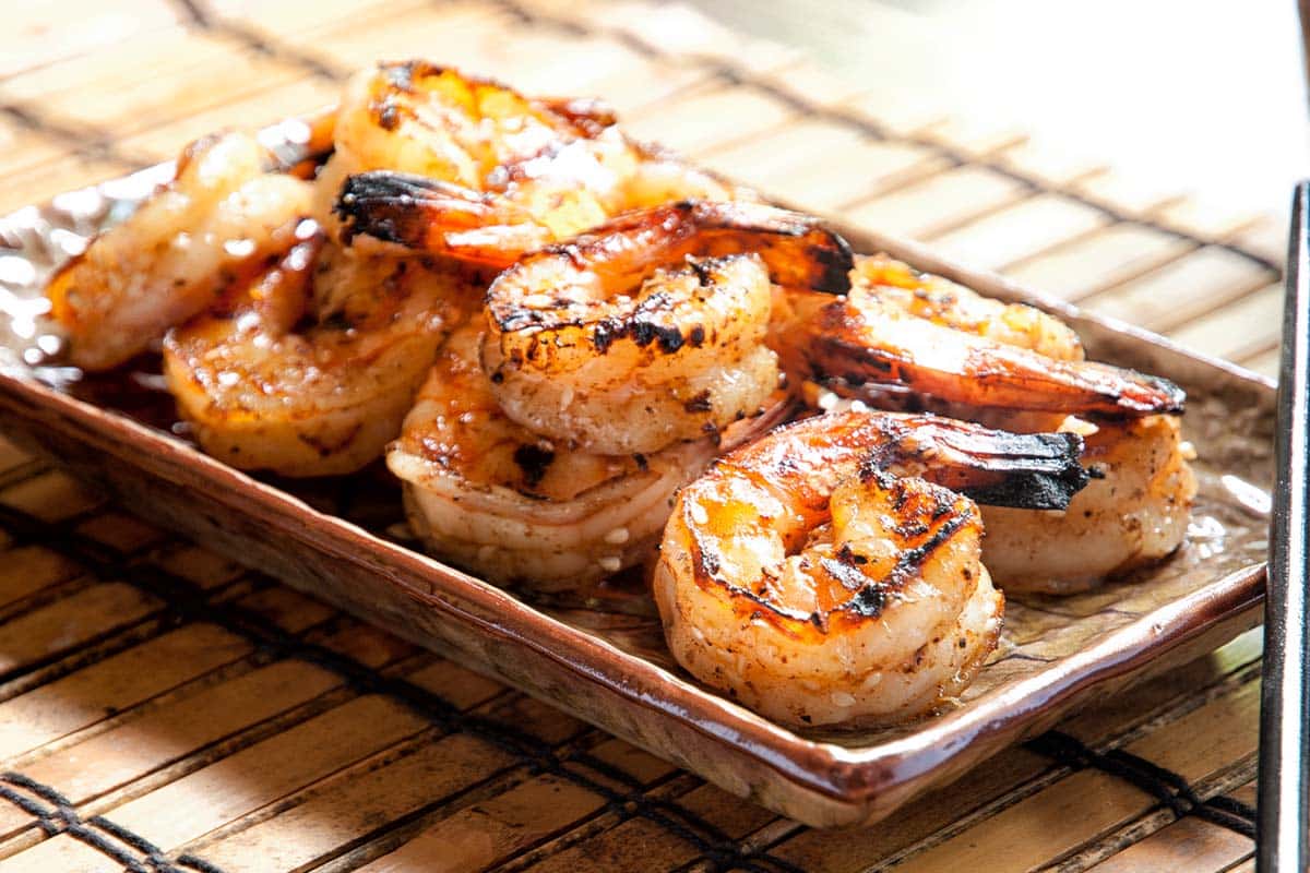 paleo-friendly asian barbecued shrimp served on a plate and bamboo mat
