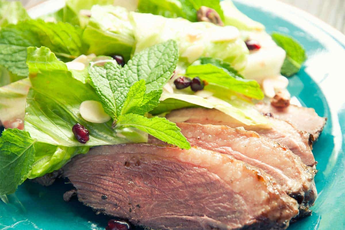 Duck and Pomegranate Salad on a blue plate