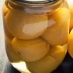 closeup of preserved lemons in a jar on a table